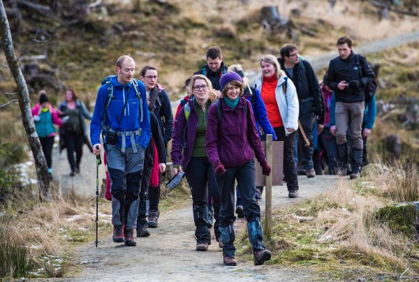 walkers on a hill path.