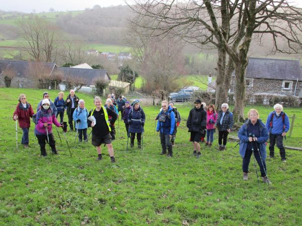 A high angle shot of walkers with a valley in the background.