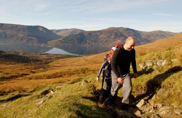 Two young people approaching the summit of Ben Lomond, Scotland, in Autumn