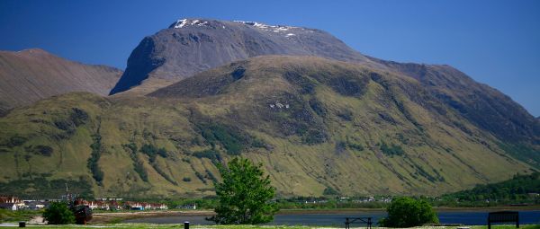 Ben Nevis the highest mountain in Britain - 1,344 metres (4,406 ft) above sea level and is located in the Lochaber area of Scotland. The Caledonial canal can be seen in the foreground, beyond is Loch Linnhe and part of the town of Fort William 