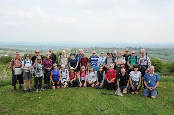 a large group of walkers at the top of a hill.