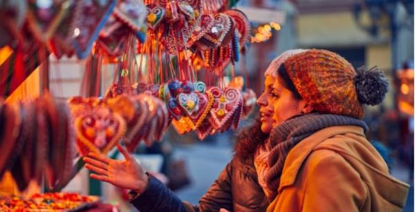 two adults at a christmas market stall