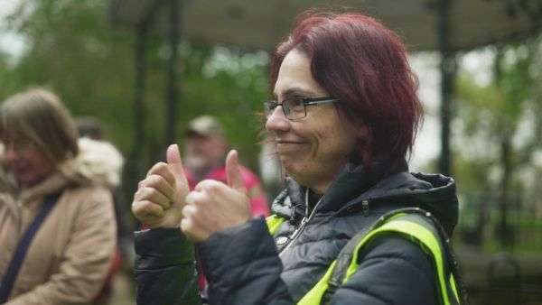 A Ramblers volunteer smiling with two thumbs up/