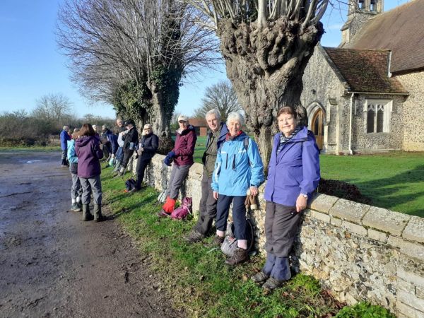 walkers leaning against a low stone wall