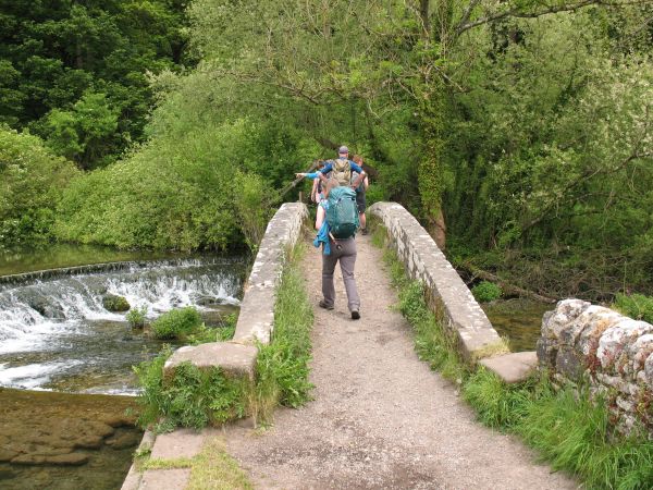 Footbridge over river with weir