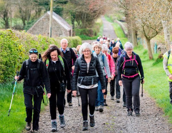 large group rambling down a country path