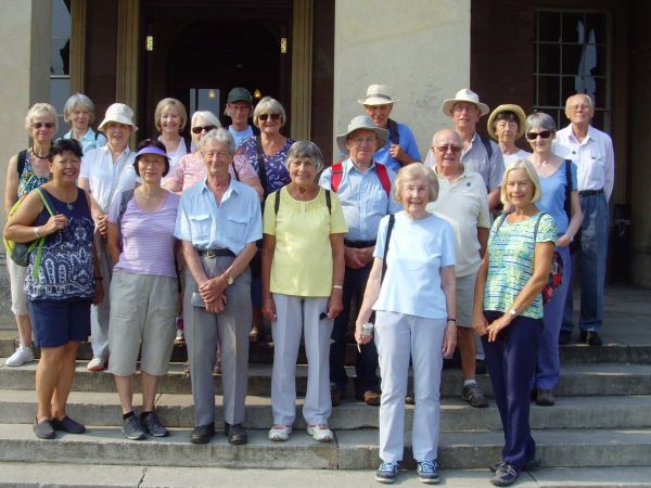 a smiling group of walkers on a building's steps