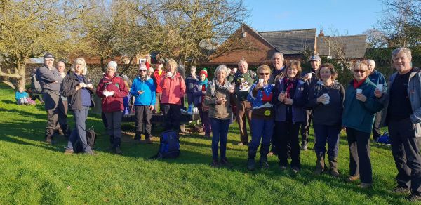 a large group of walkers outside enjoying a drink