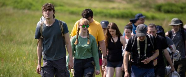 A group of walkers on a grassy track.