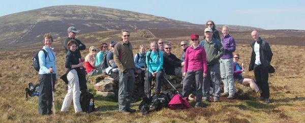 a group of walkers on a hilltop