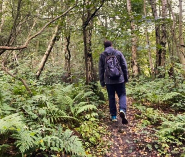 A male walker on a narrow path in Philipstoun muir