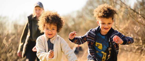 Two young children running towards us