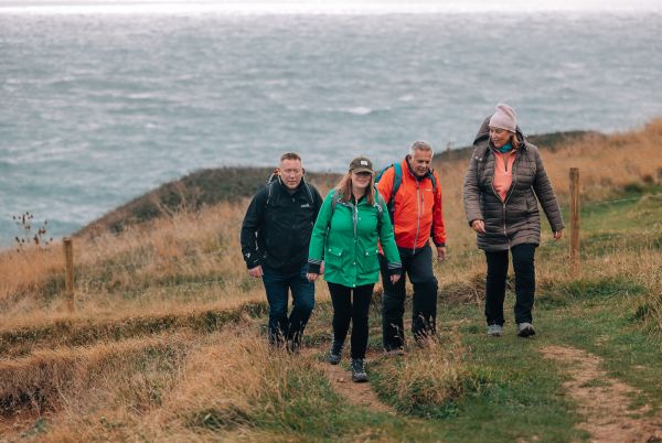 Group walking by the coast