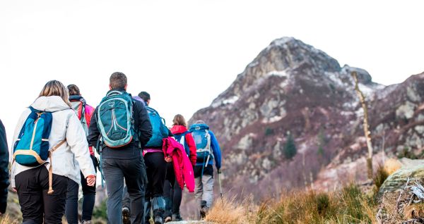 group of walkers near scottish mountain