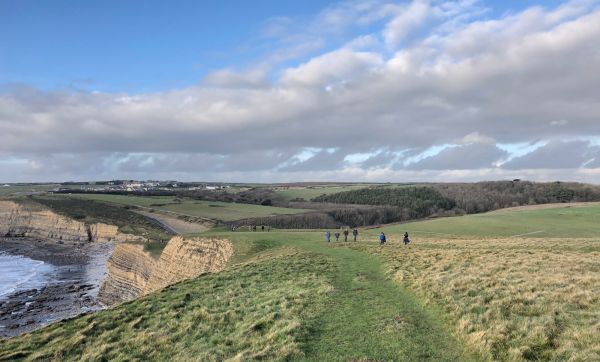 pembrokeshire coast path with walkers near a cliff