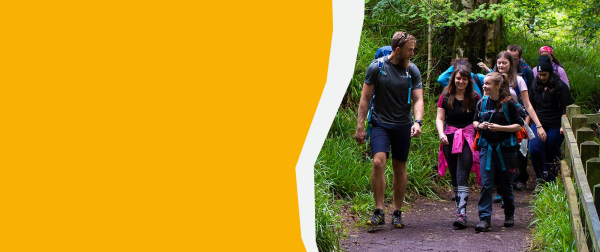 male walker guiding group on a path